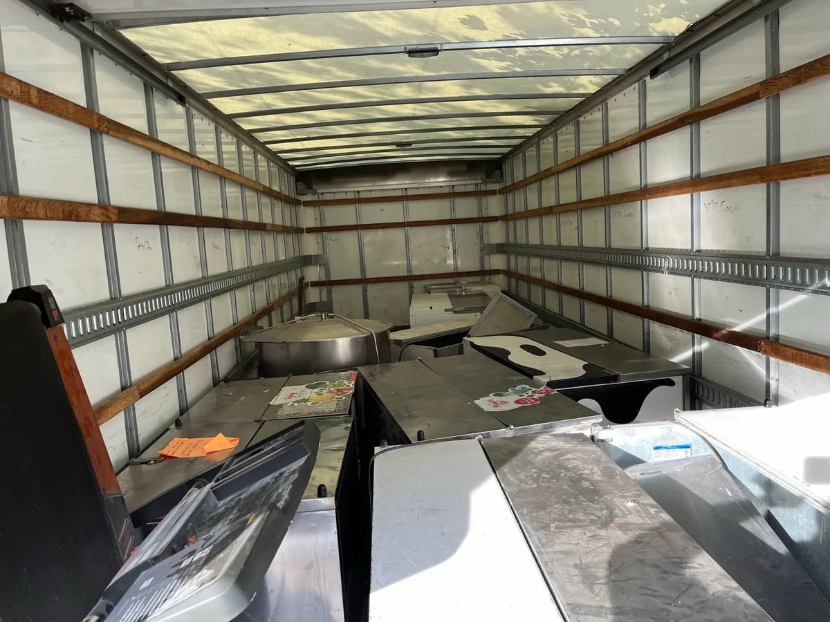 Box truck filled with used commercial appliances and scrap metal headed to the recycling yard
