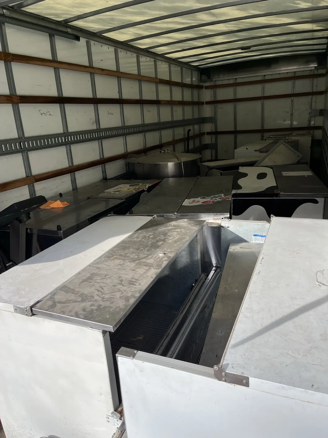 Commercial kitchen equipment and mixed scrap metal loaded inside the Indy Pickup 1111 box truck for recycling
