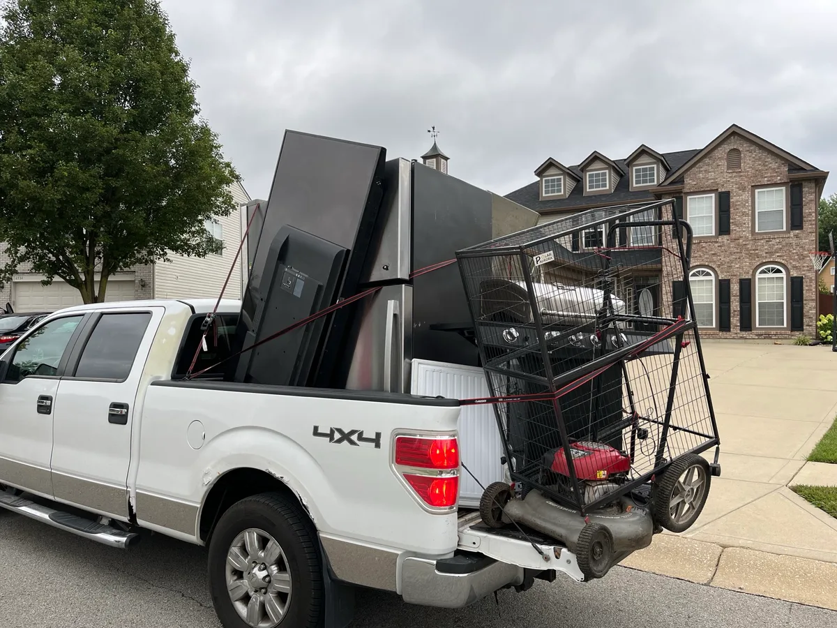 Pickup truck loaded with refrigerators and a chest freezer after a multi-appliance stop in Indianapolis