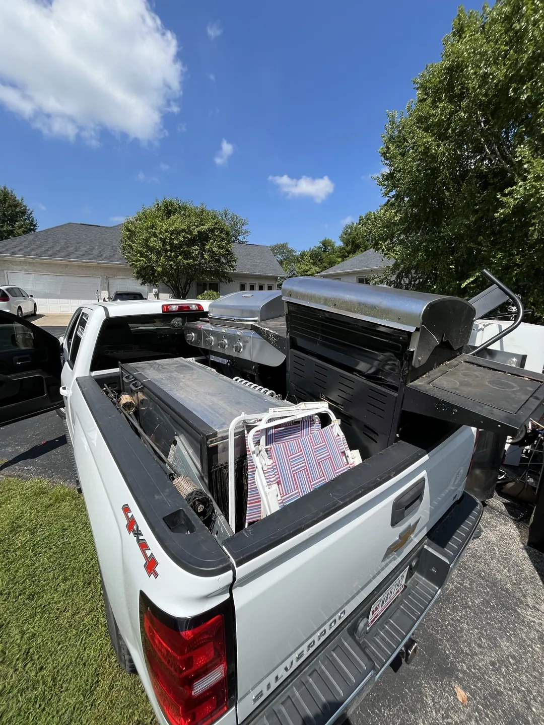 Pickup truck stacked with grills and scrap metal collected on an Indianapolis residential street