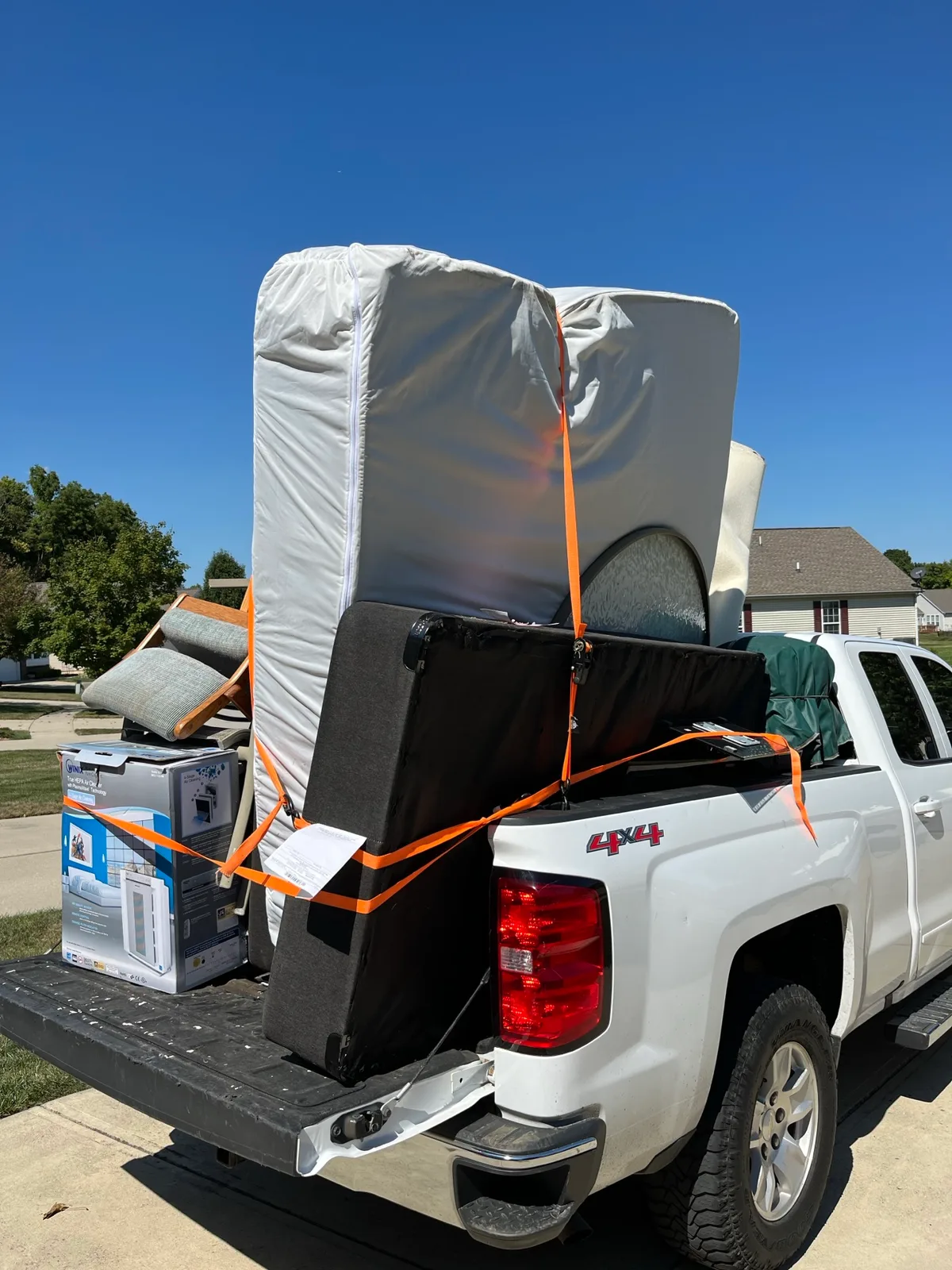 Appliances and metal staged at the curb for an Indy Pickup 1111 cleanout pickup