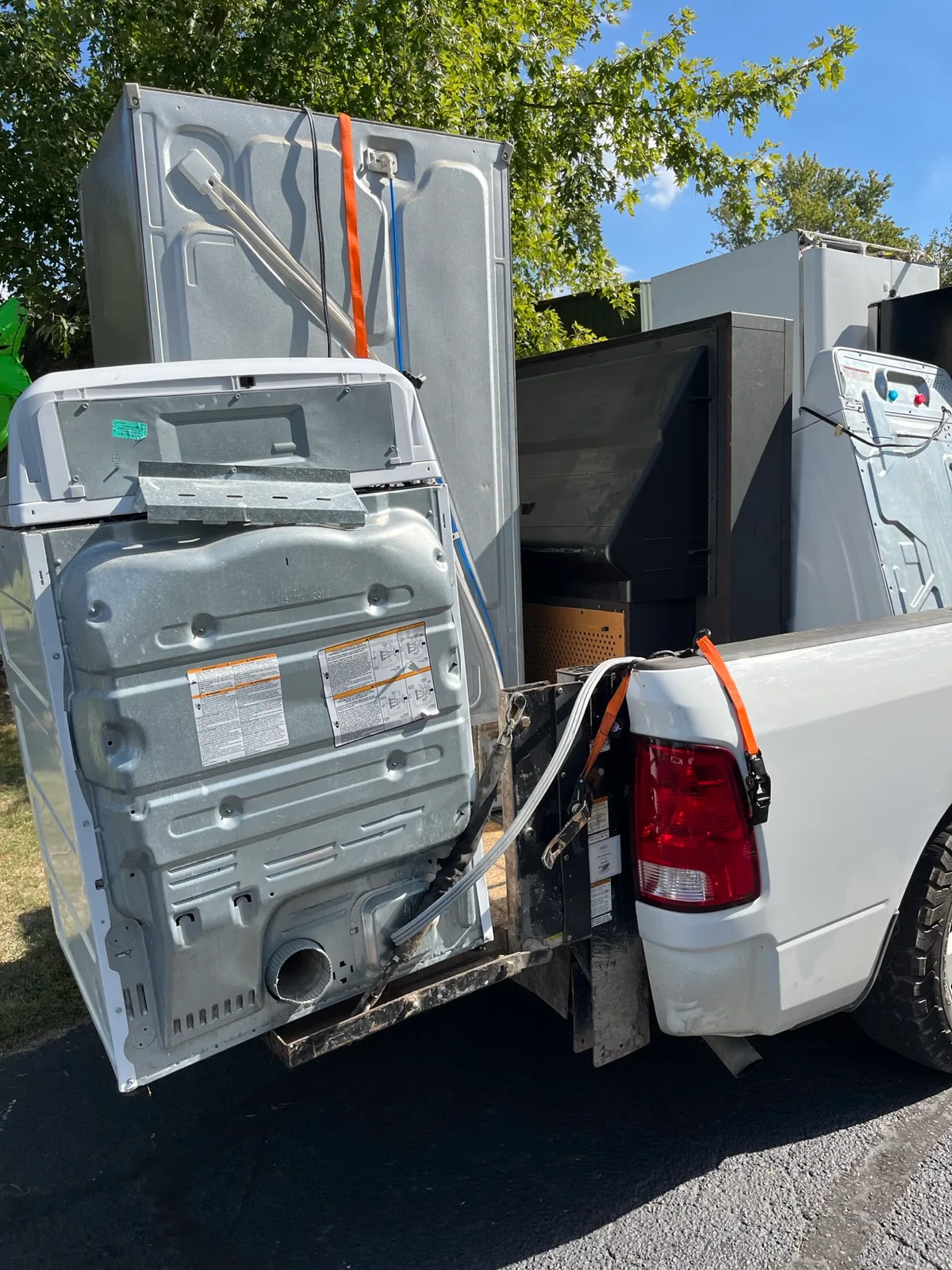 Washers and dryers strapped to a flatbed trailer after a multi-stop pickup run across Indianapolis