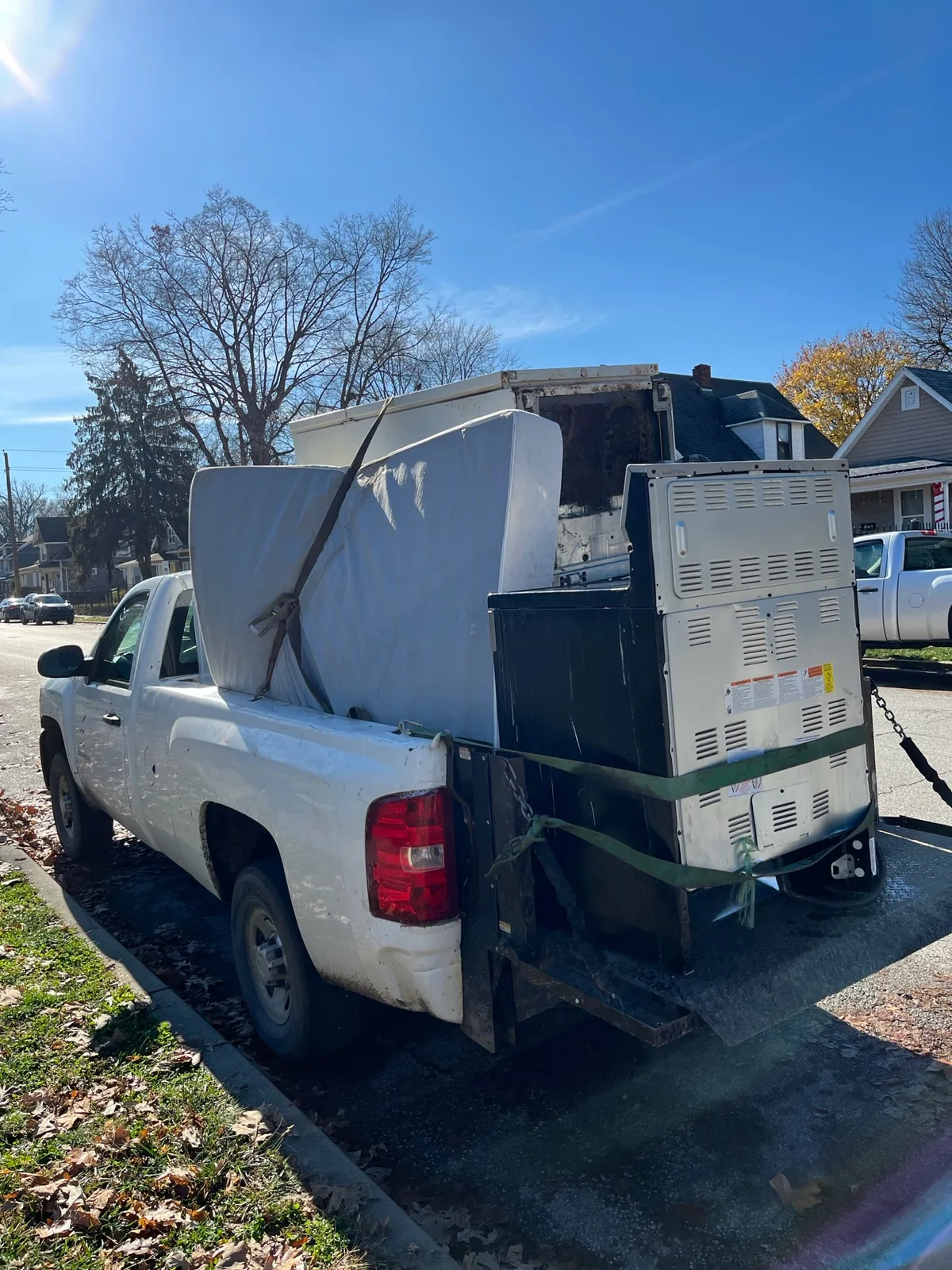 Truck loaded with an old stove and appliances during a scheduled Indianapolis pickup