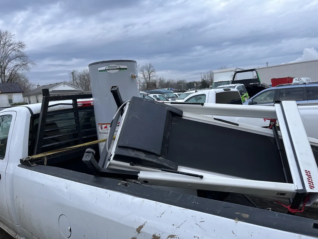 What can be picked up for scrap: an old water heater strapped into a pickup truck during an $11 Indy Pickup 1111 stop in Indianapolis